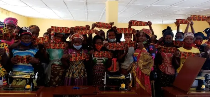 Teachers and students with sewn masks.
